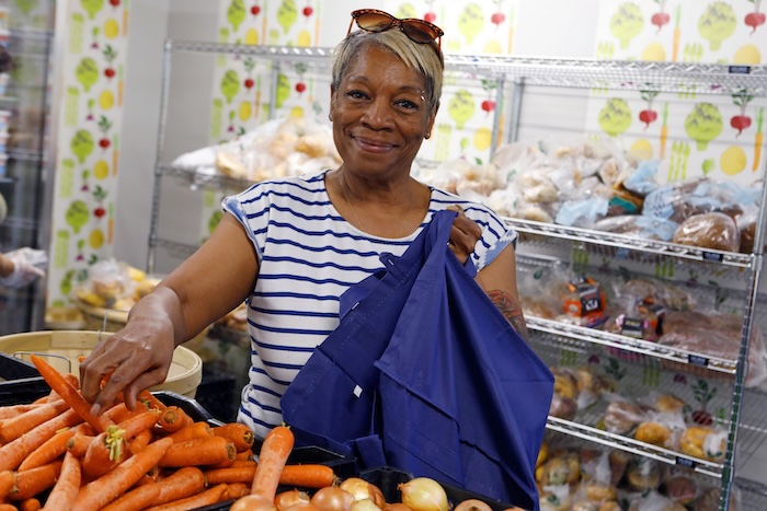 Neighbor selecting fresh produce at NOSH Delivers food pantry in Glen Cove, an Island Harvest Food Bank partner providing healthy food assistance to Long Island families in need.